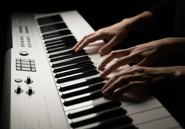 Hands playing virtual drums on a computer keyboard